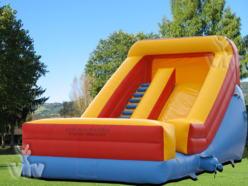 Inflatable slide with safety barriers
